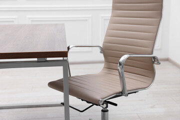 Canvas Print - Beige leather chair and desk in office