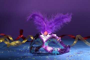 Poster - Beautiful bright carnival mask, ribbons and confetti on color background