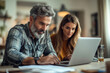 © mattegg - Couple Working Together on a Laptop at Home Office
