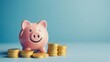 © KHF - Smiling pink piggy bank and gold coins on a blue background, representing investment success and the savings concept