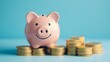 © KHF - Smiling pink piggy bank and gold coins on a blue background, representing investment success and the savings concept