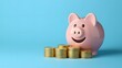 © KHF - Smiling pink piggy bank and gold coins on a blue background, representing investment success and the savings concept