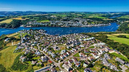 Aerial View of a Coastal Town with River and Green Hills