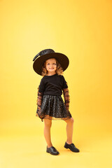 Sticker - Cute girl dressed like witch on yellow background. Halloween costume