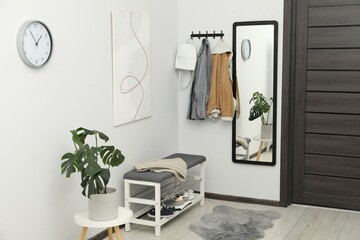 Poster - Mirror, houseplant and bench in stylish hallway