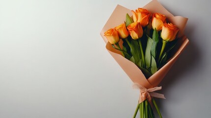 A simple yet elegant bouquet of orange roses wrapped in kraft paper, representing love, joy, passion, beauty, and new beginnings.