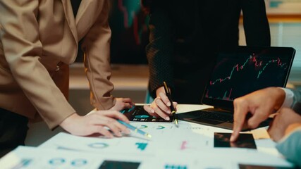 Poster - Business teams work late, analyzing financial data and charts on a laptop while collaborating on a project. Focused discussions drive strategy and decision-making in a corporate setting