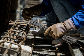 A group of builders is busy constructing a metal structure