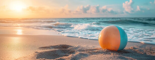 tropical summer relax pastel background Beach ball on sand at sunset