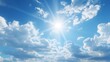 © somporn - The sun shining through a partly cloudy blue sky