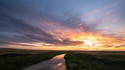 Wall Mural - Beautiful colorful sunrise over the river, red and yellow flashes. Ripples On Water Surface Of Sea Or Lake At sunrise.