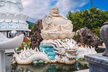 White statue of the happy Buddhist god Hotei at Linh Ung Pagoda in Da Nang in Vietnam in Asia