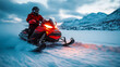 © danielkosh - Man wearing winter gear is riding a snowmobile at high speed on snow with mountains in the background