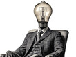 © Elena - a man sitting in a chair with a light bulb head