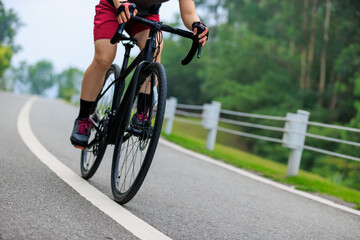 Wall Mural - Asian woman cycling at summer park