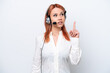 © luismolinero - Telemarketer Russian girl working with a headset isolated on white background thinking an idea pointing the finger up