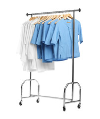 Wall Mural - Different medical workers' uniforms on clothing rack against white background