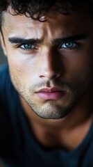 Wall Mural - Portrait of an athletic and handsome man with striking blue eyes indoors