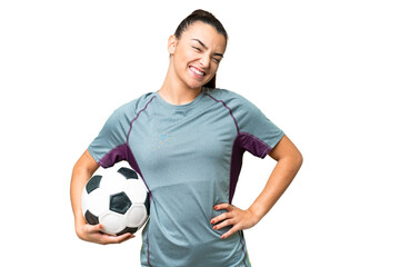 Wall Mural - Young football player Woman over isolated chroma key background posing with arms at hip and smiling