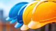 © starush - Colorful Construction Helmets in a Row Symbolizing Safety and Teamwork in Industrial Settings, AI
