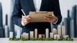 © Daylife - A business professional examines a miniature city model, holding a clipboard, suggesting planning or development in architecture and urban design.
