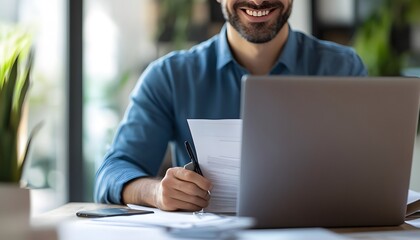 Poster - Smiling Man Reviewing Documents at Desk with Laptop