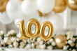 © Neira - Helium golden balloons in shape of number 100. Birthday jubilee party or wedding anniversary for one hundred years celebration. Elegant white decorations. 100 followers or likes in social media
