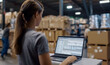 © goami - woman manages inventory on laptop in warehouse, role of technology and analytics in streamlining logistics, shipping, and stock control in modern industrial settings