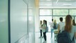 © dee-nesia - white blank wall mockup with defocus people walking in a corridor of a school, campus, or airport