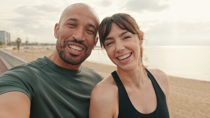 Portrait of an active happy fit couple of athletes taking selfie during morning workout