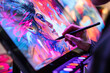 © Degimages - Artist using a graphics tablet and stylus to create vibrant digital artwork on screen