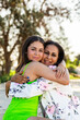 © Austockphoto - Portrait of Torres Strait Islander mother in her thirties and young daughter together on the beach