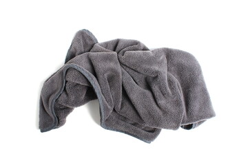  A small grey towel lies crumpled on a white background.