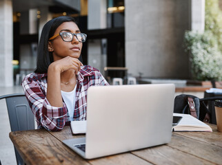 Sticker - Student, woman and thinking in cafe, laptop and serious with notebook, table and practice for college. University, digital and person in coffee shop, learning and planning for exam, knowledge or tech