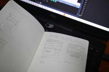 Photo of the notebook with sketches on the laptop