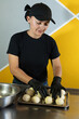 © Andrey - beautiful woman pastry chef kneads the dough for the fritters that are ready to be baked