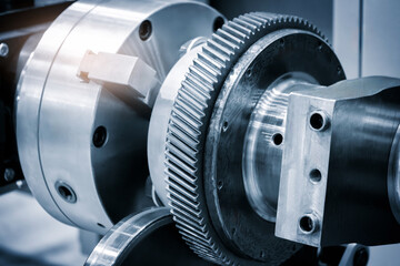 Poster - A machine with a gear and a tool. The machine is made of metal and has a shiny surface