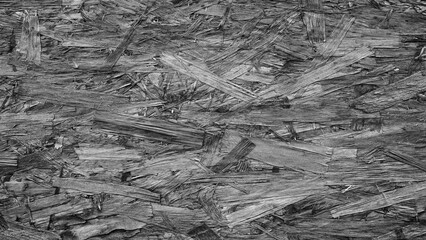 Poster - A pile of wood chips cray color texture background. The pile is made up of small pieces of wood