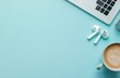 © Georgii - Minimalist setup with MacBook, AirPods, and a coffee on a light blue desk for a modern workspace concept