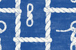 © Luluraschi - Seamless repetitive pattern background of hand-drawn nautical knots and ropes on a faded blue backdrop