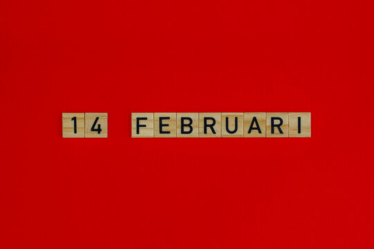 14 february in wooden blocks on a red background. Valentine's day concept. Dutch language