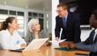 © JackF - Positive partner men and women discussing a problem sitting around table in meeting room