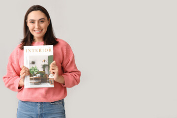 Canvas Print - Beautiful woman with interior magazine on light background