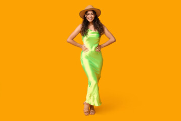 Poster - Stylish African-American woman in dress and hat on yellow background