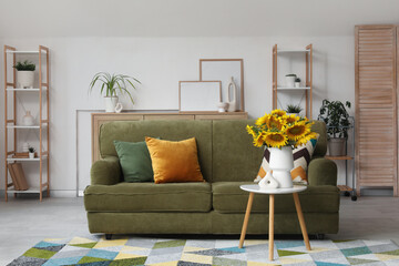 Canvas Print - Interior of living room with green sofa and sunflowers on coffee table