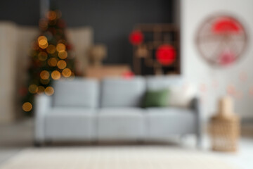 Wall Mural - Blurred view of living room with sofa, fir tree and decor for Japanese New Year celebration