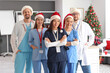 © Pixel-Shot - Group of doctors in Santa hats at hospital on Christmas eve