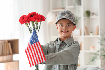 Wall Mural - Cute little boy with USA flag and carnation flowers at home. Veterans Day celebration