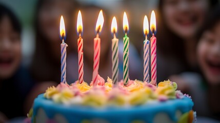 Poster - Joyful birthday celebration with a colorful cake adorned with lit candles, surrounded by a happy, blurry group of friends and family  