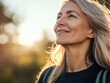 © kora studio - smiling middle age older silver hair blonde woman is hiking on the hill for fun , feel fresh and happy with sun light